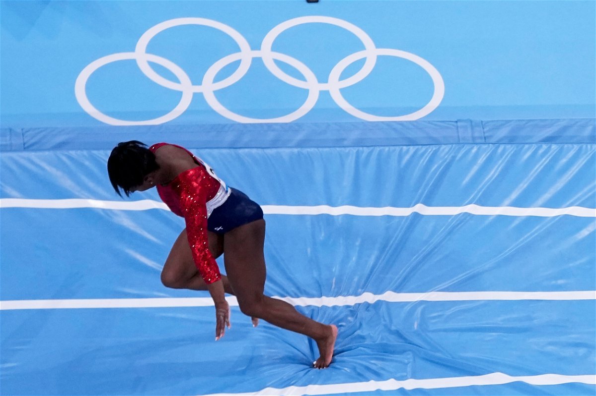 <i>Morry Gash/AP</i><br/>Simone Biles stumbles as she lands during the artistic gymnastics women's final at the 2020 Summer Olympics on Tuesday.