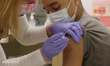 A patient receives the Covid-19 vaccine at office of CNN Hero Dr. Wendy Ross.