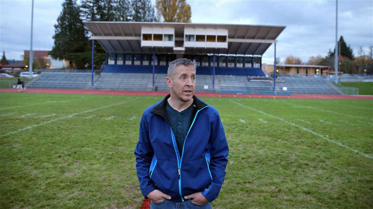 <i>Larry Steagall/Kitsap Sun via AP</i><br/>Former Bremerton High School assistant football coach Joe Kennedy stands at the center of the field on the 50 yard line at Bremerton Memorial Stadium
