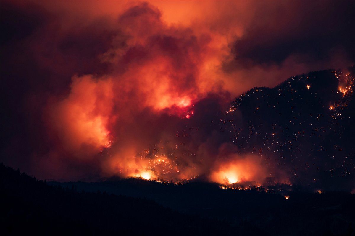 <i>Darryl Dyck/The Canadian Press/AP</i><br/>A wildfire burns on the side of a mountain in Lytton on July 1.