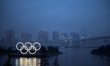 This general view shows the Olympic Rings lit up at dusk on the Odaiba waterfront in Tokyo on July 9