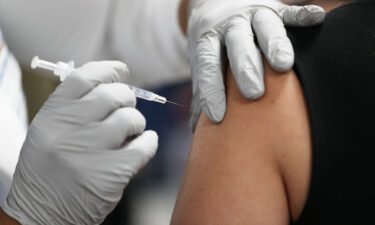 A healthcare worker at the Jackson Health Systems receives a Pfizer-BioNtech Covid-19 vaccine at the Jackson Memorial Hospital in 2020 in Miami