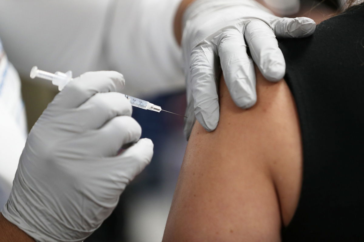 <i>Joe Raedle/Getty Images</i><br />A healthcare worker at the Jackson Health Systems receives a Pfizer-BioNtech Covid-19 vaccine at the Jackson Memorial Hospital in 2020 in Miami