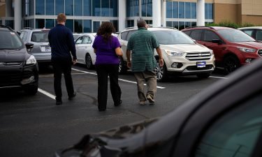 Customers shop for used vehicles at a CarMax dealership in Louisville