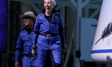 Blue Origin's New Shepard crew (L-R) Jeff Bezos and Wally Funk arrive for a press conference after flying into space in the Blue Origin New Shepard rocket on July 20 in Van Horn