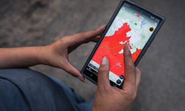A resident uses a smartphone mapping app to view the latest information about the Bootleg fire in the mountains north of Bly