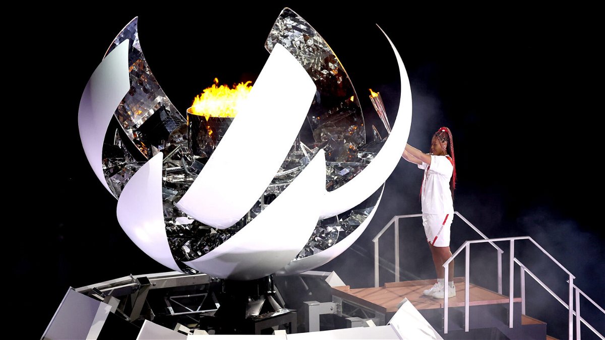 <i>Maja Hitij/Getty Images</i><br/>Naomi Osaka of Team Japan lights the Olympic cauldron with the Olympic torch during the Opening Ceremony of the games.