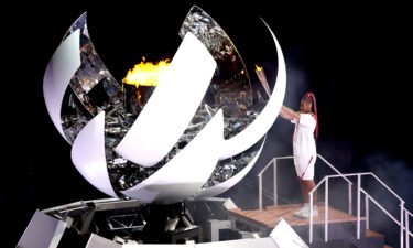 Naomi Osaka of Team Japan lights the Olympic cauldron with the Olympic torch during the Opening Ceremony of the games.