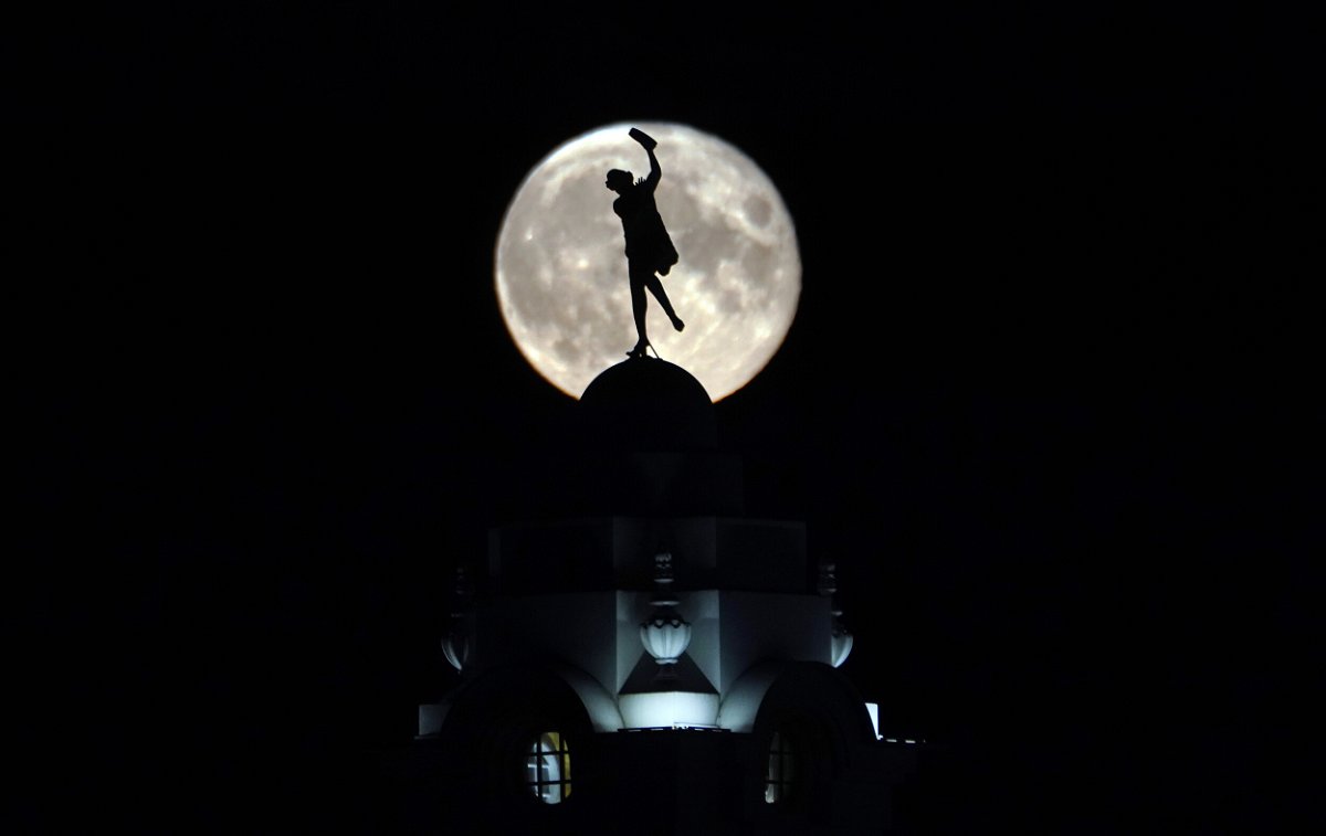 <i>Press Association/Sipa USA</i><br/>The full buck moon rises over a dancing lady on the Spanish City building in Whitley Bay