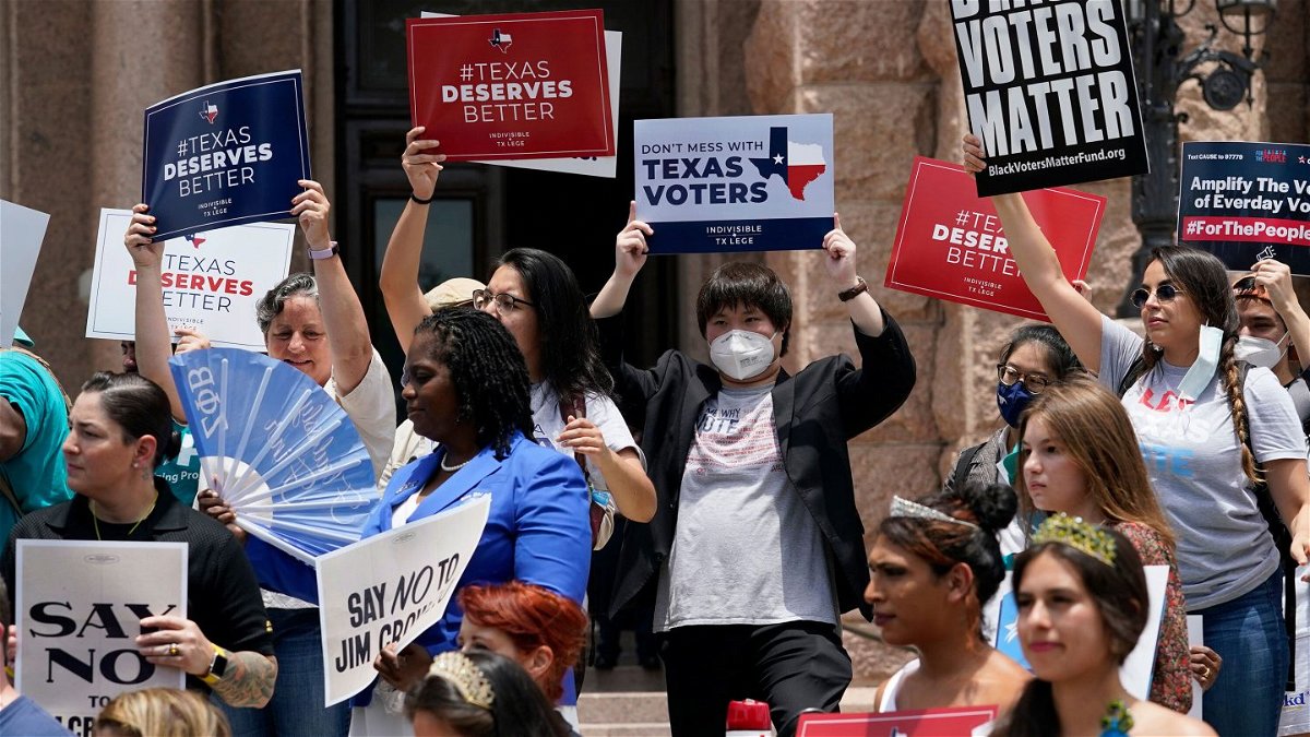<i>Eric Gay/AP</i><br/>Demonstrators join a rally to protest proposed voting bills on the steps of the Texas Capitol