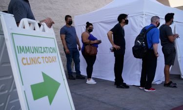 People wait in line for Covid-19 vaccinations at an event at La Bonita market