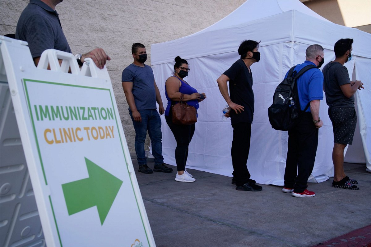 <i>John Locher/AP</i><br/>People wait in line for Covid-19 vaccinations at an event at La Bonita market