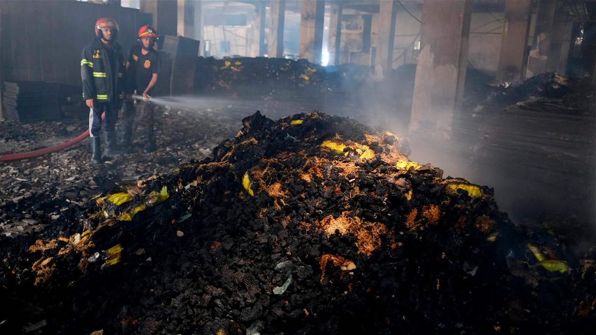 <i>Mahmud Hossain Opu/AP</i><br/>Firefighters work to douse the fire at the factory on Friday.