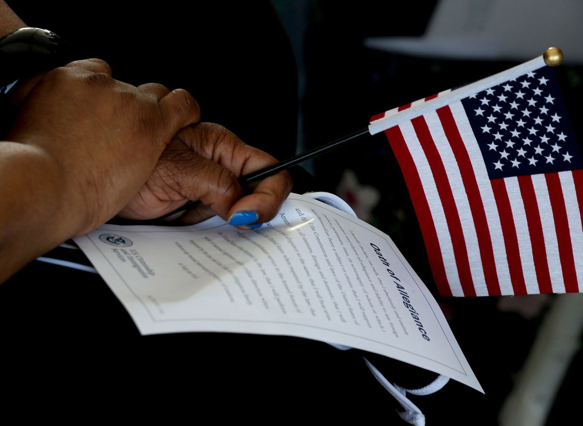 <i>Luis Sinco/Los Angeles Times/Shutterstock</i><br/>The Biden administration is introducing an unprecedented effort to encourage eligible immigrants to apply for US citizenship. An immigrant is seen during a naturalization ceremony in Los Angeles on Thursday