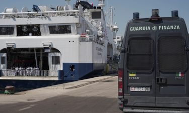 An Italian law enforcement vehicle parked next to the ship "Geo Barents" while migrants wait to disembark in Sicily on June 18.