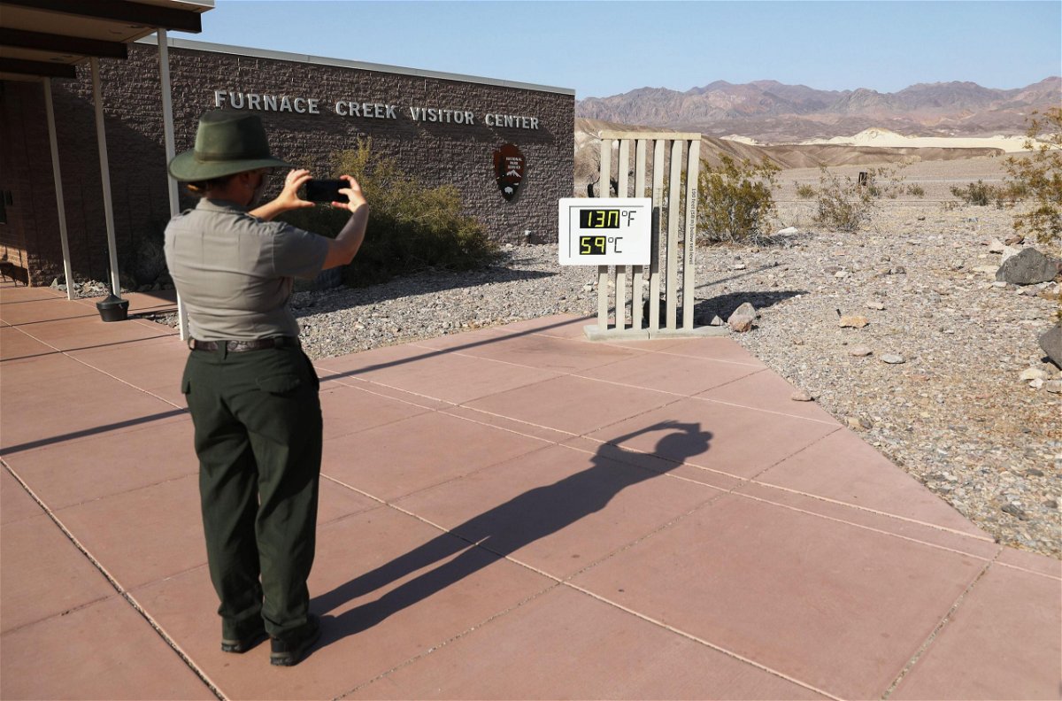 <i>Mario Tama/Getty Images</i><br/>A park ranger takes a picture of an unofficial thermometer at Furnace Creek Visitor Center in California's Death Valley National Park on August 17