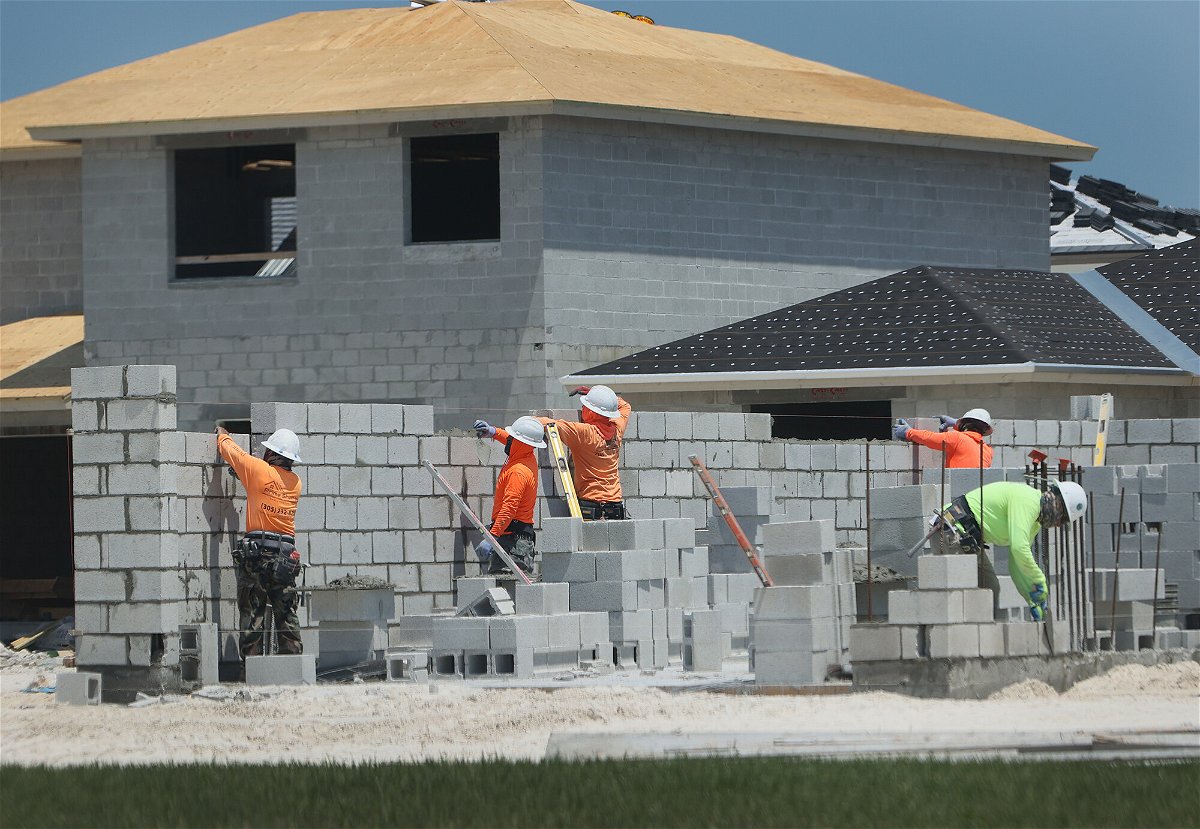 <i>Joe Raedle/Getty Images</i><br/>Construction workers build a home on April 16 in Miami