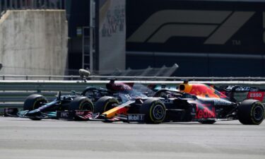 Hamilton and Max Verstappen take a curve side-by-side at the start of the British Grand Prix.