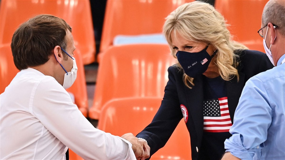 <i>Andrej Isakovic/AFP/Getty Images</i><br/>French President Emmanuel Macron and First Lady Jill Biden shake hands ahead of the women's first round 3x3 basketball match between the US and France.