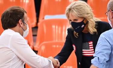 French President Emmanuel Macron and First Lady Jill Biden shake hands ahead of the women's first round 3x3 basketball match between the US and France.