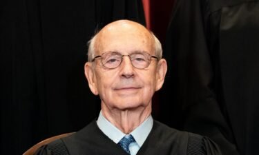 Associate Justice Stephen Breyer sits during a group photo of the Justices at the Supreme Court in Washington
