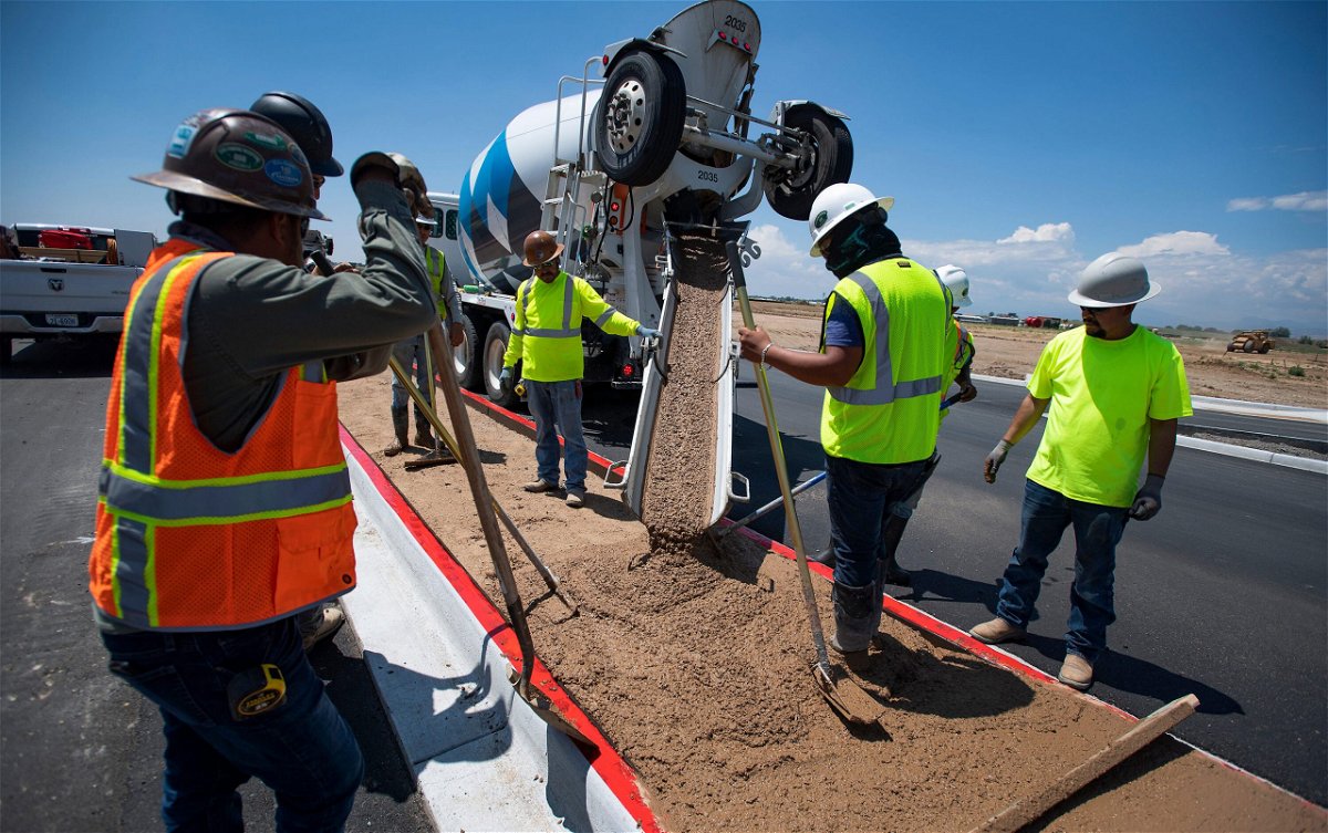 <i>Bethany Baker/The Coloradoan/USA Today Network</i><br/>Construction workers pour concrete into a median along Larimer County Road 5 near Windsor