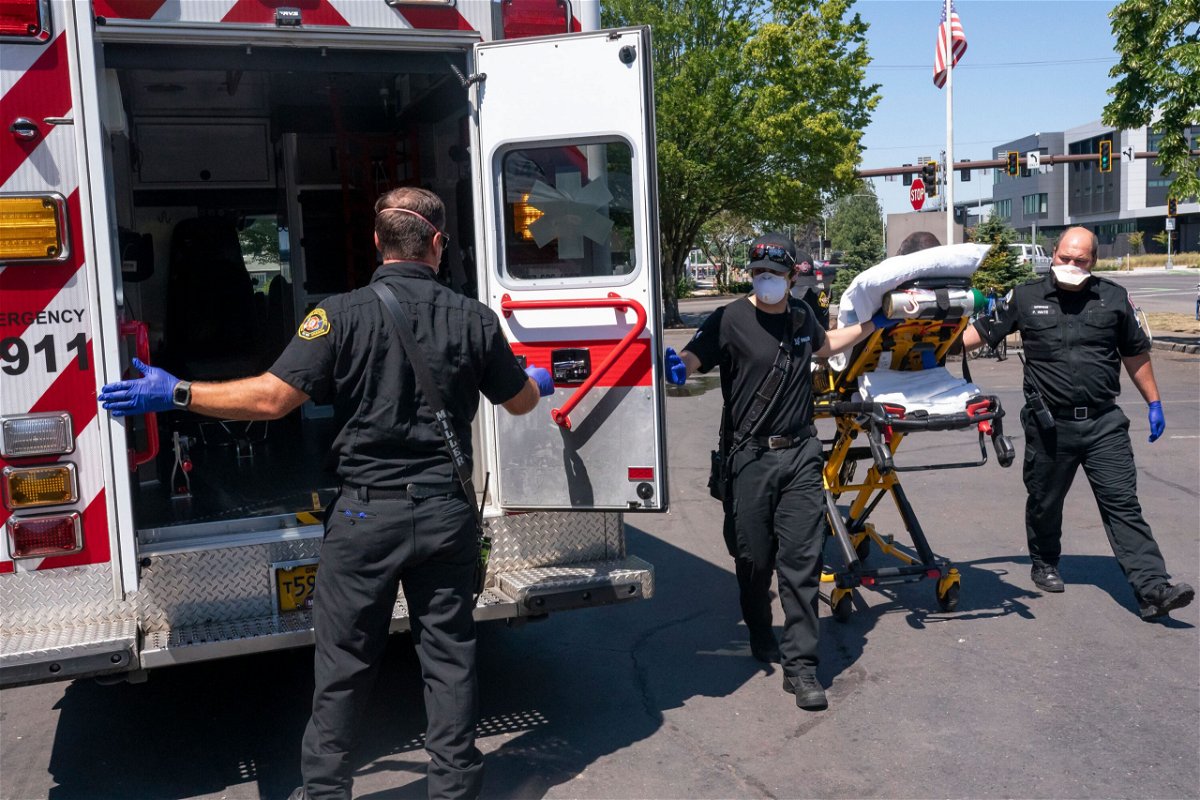 <i>Nathan Howard/AP</i><br/>Salem Fire Department paramedics and employees of Falck Northwest ambulances respond to a heat exposure call during a heat wave on June 26 in Salem