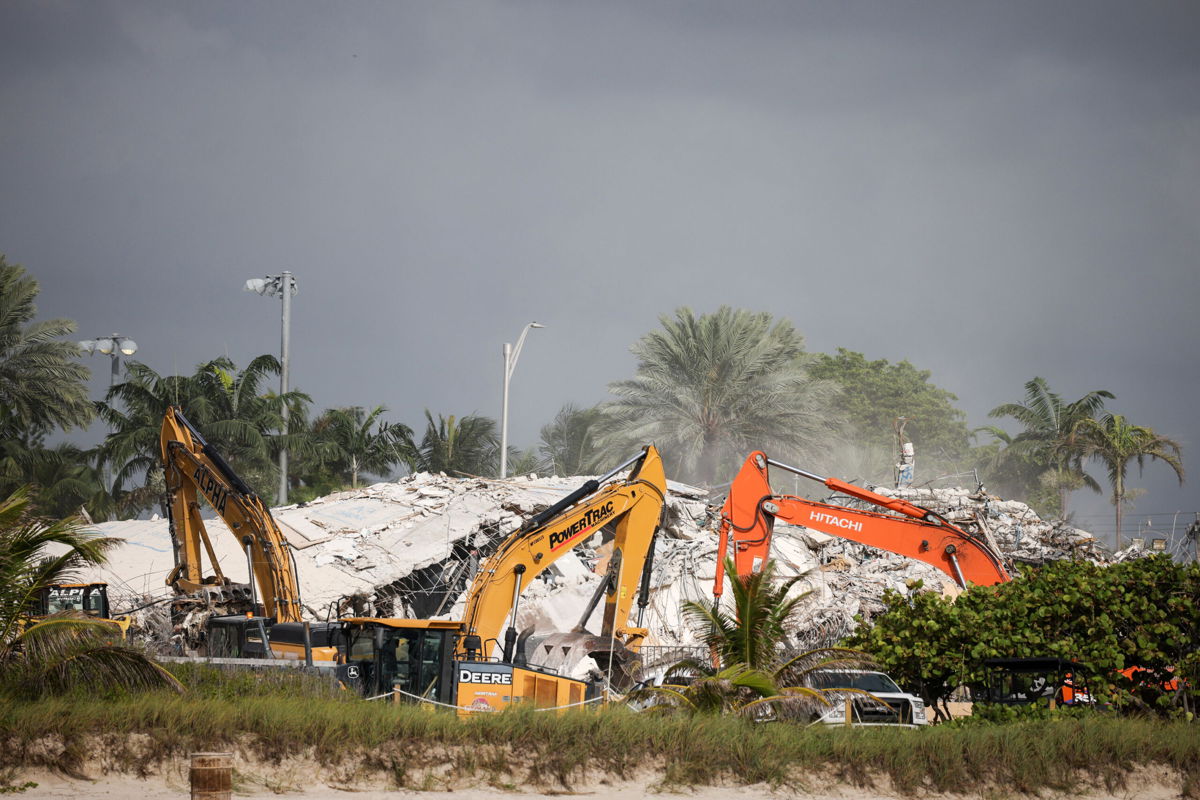 <i>Anna Moneymaker/Getty Images</i><br/>Rescue workers use excavators to dig through the rubble of the collapsed 12-story Champlain Towers South condo building on July 9 in Surfside