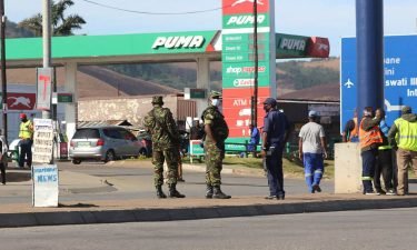 eSwatini soldiers and police officers are seen on the streets near the Oshoek Border Post between Eswatini and South Africa on July 1.