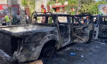 Burned-out cars can be seen where the police engaged in a gun battle with the suspected assassins near Haiti's national palace on Route de Kenschoff.