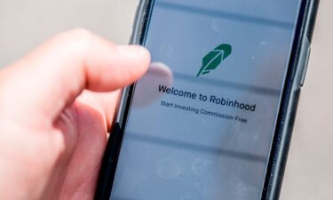 The Robinhood investment app is seen on a smartphone in this photo illustration. Robinhood makes its Wall Street debut on Thursday.