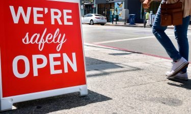 A sign announces that a restaurant is "safely open" in Los Angeles
