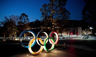 The Olympic rings are displayed outside the National Stadium