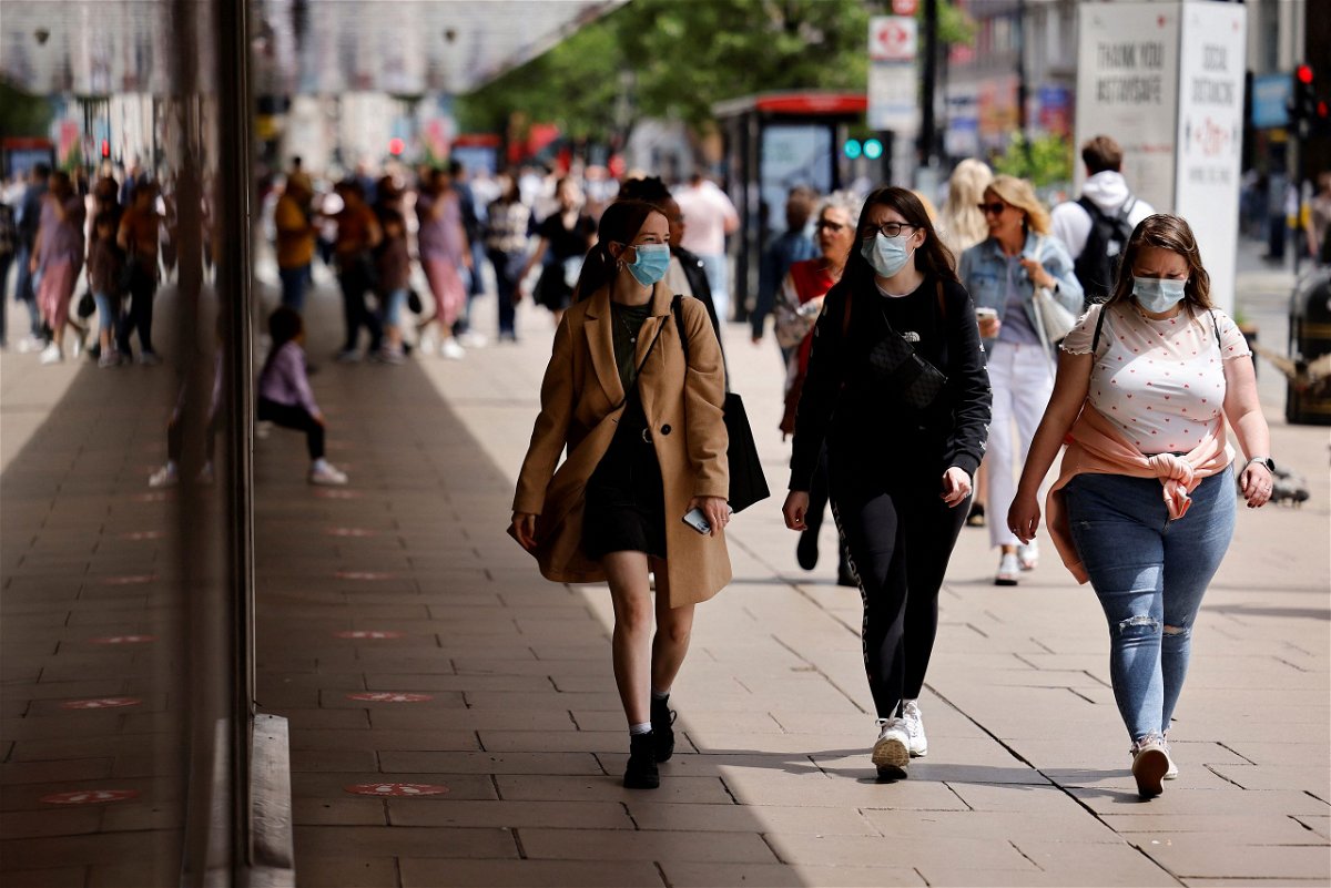<i>Tolga Akmen/AFP/Getty Images</i><br/>Pedestrians wear face masks while walking along Oxford Street in central London on June 6. UK Prime Minister Boris Johnson is setting out his plan to lift most of England's remaining coronavirus restrictions by mid-July.