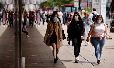 Pedestrians wearing a face mask or covering due to the Covid-19 pandemic