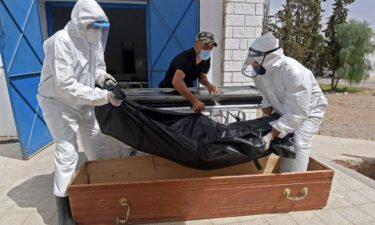 The body of a Covid-19 victim is placed into a casket at the Ibn al-Jazzar hospital in the Tunisian city of Kairouan on July 4.