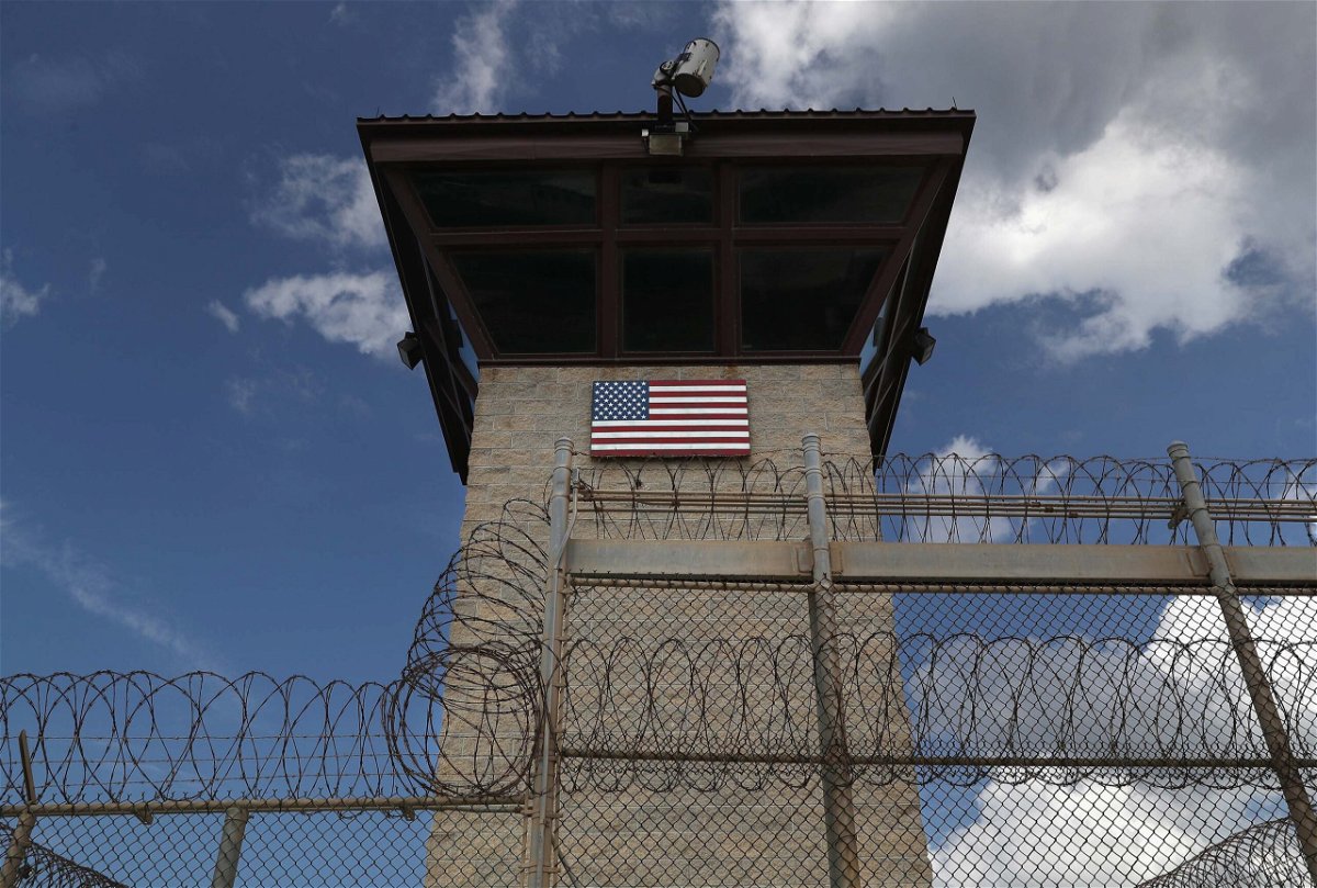 <i>John Moore/Getty Images</i><br/>A guard tower stands at the entrance of the US prison at Guantanamo Bay on October 23