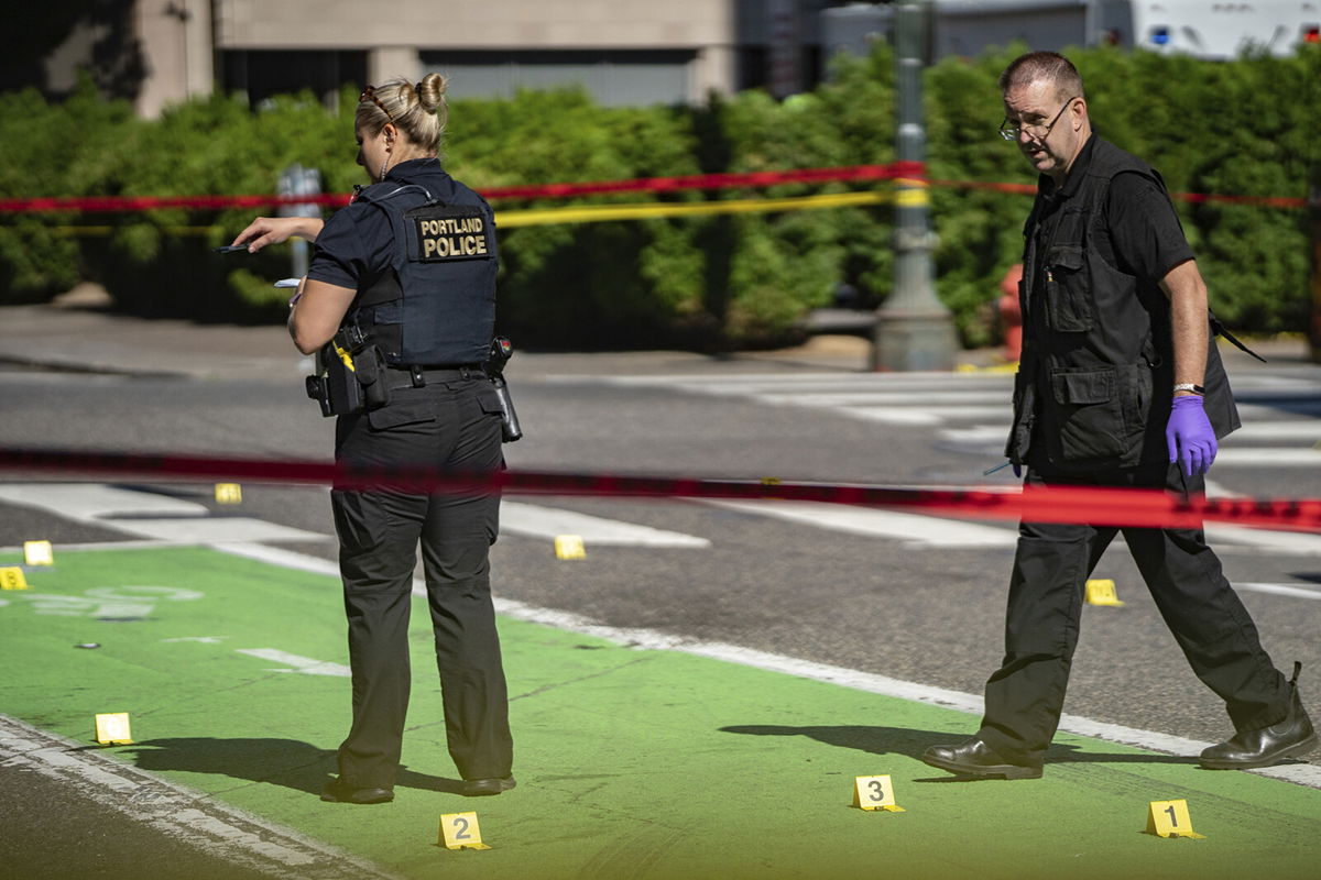 <i>Mark Graves/Oregonian/AP</i><br/>Police investigate an overnight shooting on July 17 in Portland