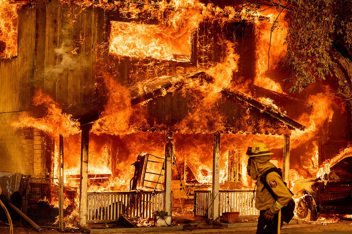 <i>Noah Berger/AP</i><br/>Fire consumes a home as the Sugar Fire