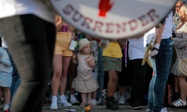 A young girl watches a loyalist marching band parade through west Belfast on July 10.