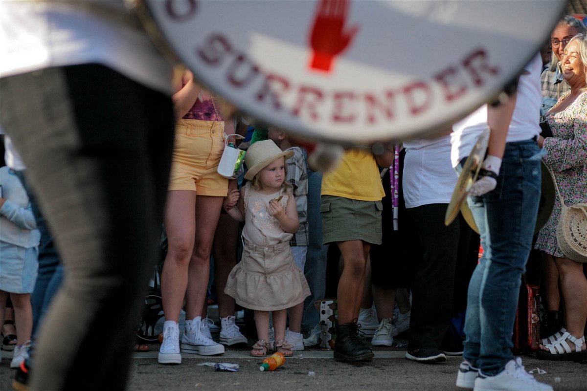 <i>Kara Fox/CNN</i><br/>A young girl watches a loyalist marching band parade through west Belfast on July 10.