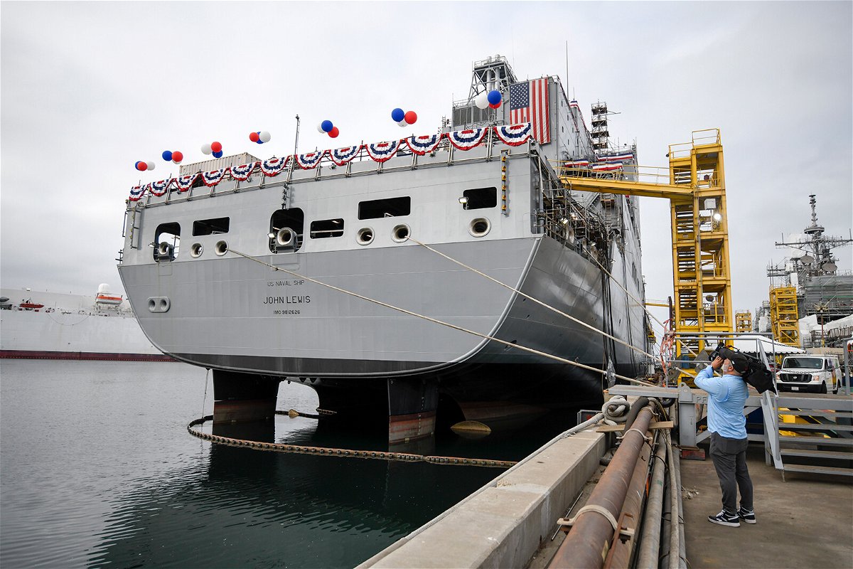 <i>Denis Poroy/AP</i><br/>A television cameraman videotapes the USNS John Lewis before a christening ceremony on July 17 in San Diego.
