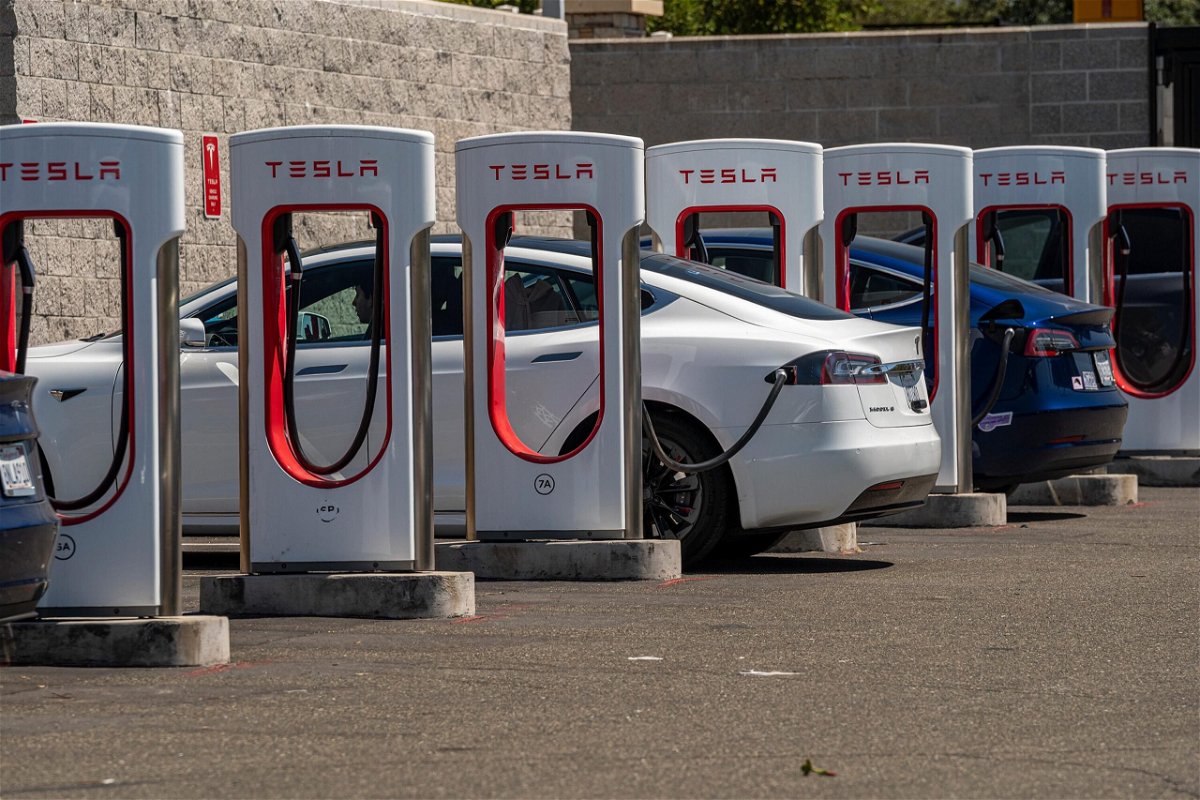 <i>David Paul Morris/Bloomberg/Getty Images</i><br/>Tesla vehicles at charging stations outside a store in Rocklin
