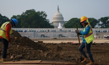 Workers repair a park near the Capitol in Washington on July 21 as senators struggle to reach a compromise over how to pay for nearly $1 trillion in public works spending