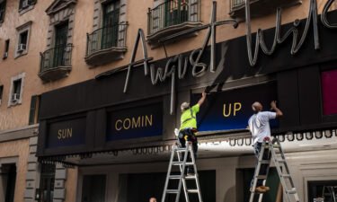 Workers replace signs at the August Wilson Theatre in New York City on June 29. More than a year into a global pandemic and amid an international social justice movement