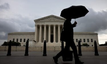 A morning commuter walks passed the U.S. Supreme Court on June 22 in Washington