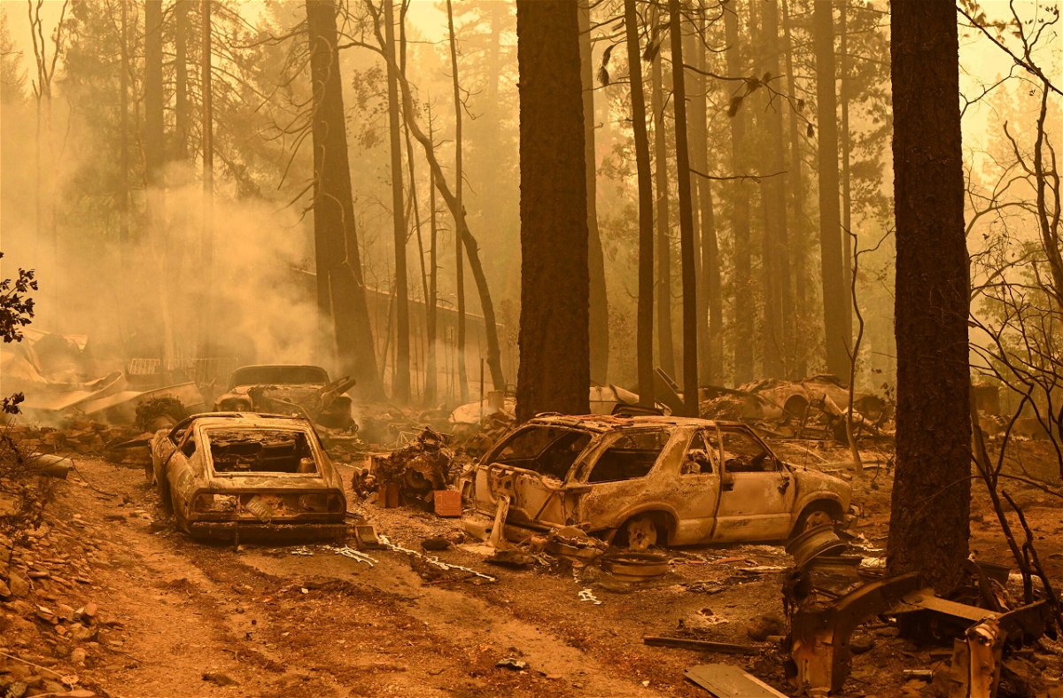 <i>Josh Edelson/AFP/Getty Images</i><br/>Burned vehicles smolder at a property during the Dixie fire in the Indian Falls area of unincorporated Plumas County.