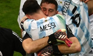 Argentina's goalkeeper Emiliano Martinez and Argentina's Lionel Messi embraces Emiliano Martinez after the goalkeeper's shootout heroics.
