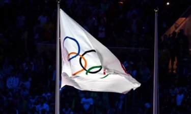 The Olympic flag atop a flag pole
