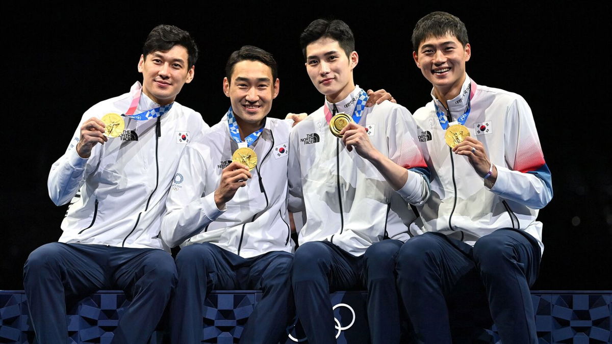 Korea poses with their gold medals in the men's sabre team event